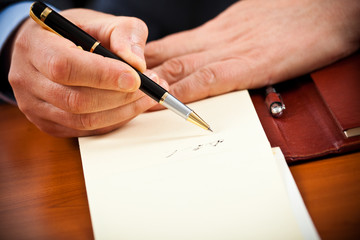 Businessman writing some documents