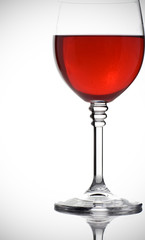 glass of red wine on white