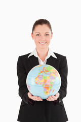 Beautiful woman in suit holding a globe