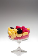 jelly beans in a glass on gradient background