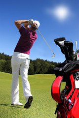 Man playing golf with golf bag