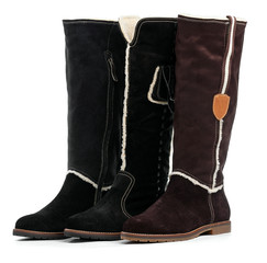 Three different female winter boots over white