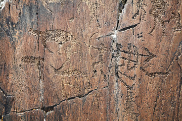 petroglyph of hunters in Kazakhstan