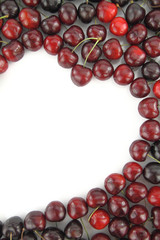 Cherry border in shape of heart on white background
