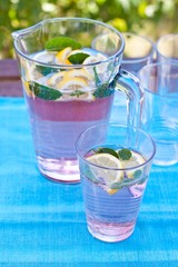 Summer drink with lemon, berries and mint