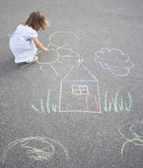 Little girl drawing outdoors