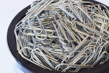 a heap of paperclips in an organizer