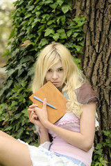 Girl with book outdoor.