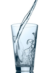 Pouring water into glass isolated on white background