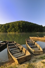 Fototapeta na wymiar Fishing boats on the lake lit by the morning light