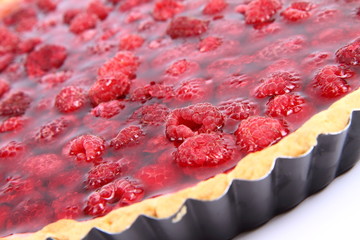 Raspberry Tart in a tart pan on a white background