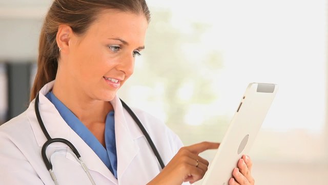 Female doctor using a tablet computer