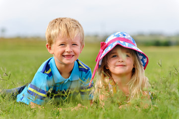 Young blond children in field