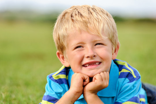 Cute Caucasian Kid Smiling Outdoors