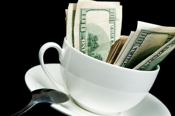 white cup full of dollars