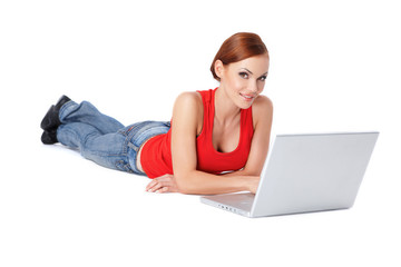 Cute female lying down and using a laptop