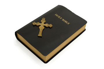 Closed bible with a cross isolated on white