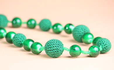 Green necklace at pink background