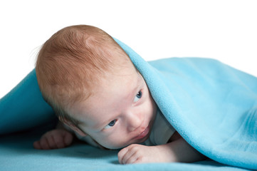 2 months old baby boy covered in blue blanket