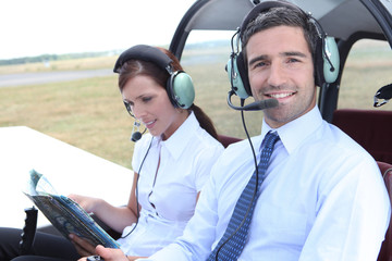 man sitting in the cockpit of a light aircraft wiht his partner
