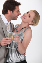 Flirtatious man and woman drinking champagne
