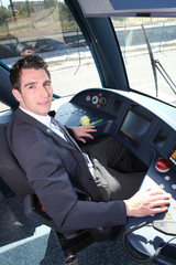 Young man driving tram