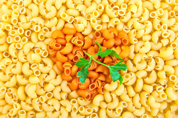 Pasta with yellow with orange hearts and parsley
