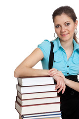 Beautiful student is holding a lot of books