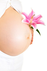 Pregnant woman holding lillies isolated on white