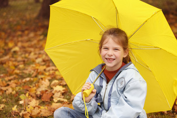 happy girl with yellow ubrella