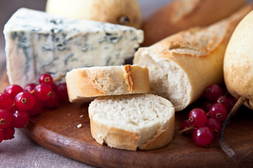 closeup of baguette,blue cheese and currant on chopping board