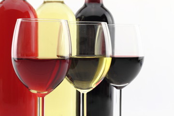 Three colors of wine in bottles and glasses