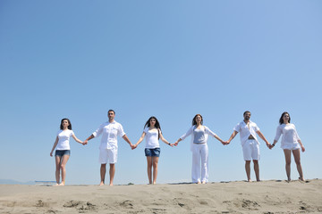 Naklejka premium happy people group have fun and running on beach