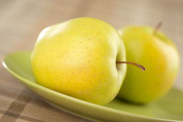 fresh green apple on plate