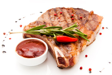 Closeup of grilled steak with peper corns and rosemary