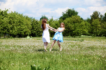 Naklejka na ściany i meble two girls playing in the park