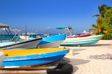 colorful tropical boats beached in sand Isla Mujeres