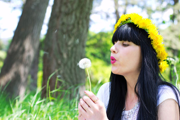 Young woman with dandelion