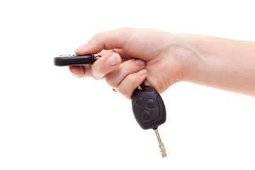 Hand with alarm keys pushing the button. Isolated on white