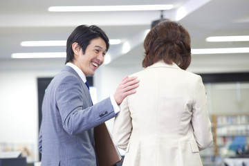 オフィスで会話をしているOLとビジネスマン