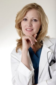 Lady blond caucasian doctor with hand on chin