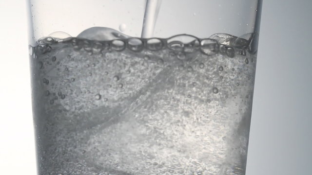 Pouring glass of soda water