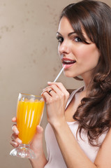 Close-up of woman drinking orange juice