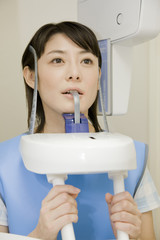歯のレントゲンを撮られる女性