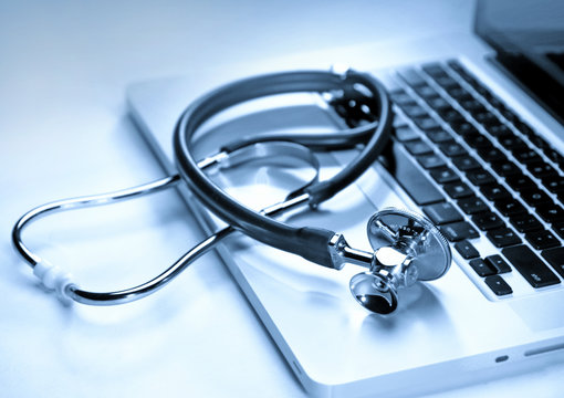 Medical stethoscope on a laptop, closeup