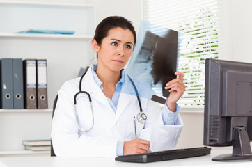 Charming female doctor looking at a x-ray