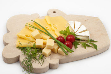 Various types of cheese on a wooden board