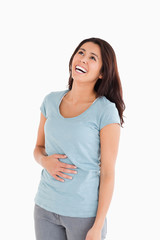 Fototapeta premium Joyful beautiful woman laughing while standing
