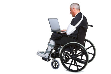 Injured businessman on laptop in a wheelchair isolated