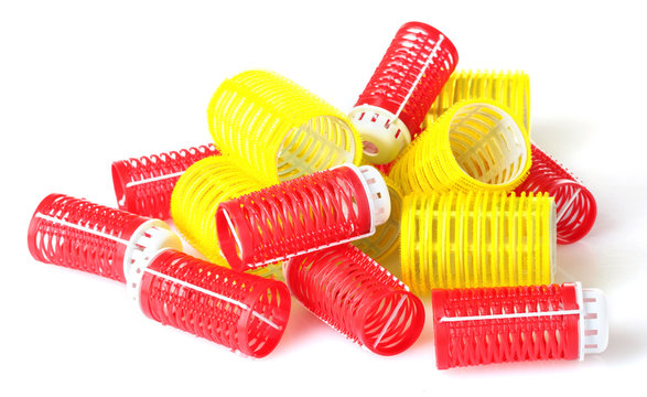 red and yellow curlers isolated on white